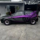 VW Gol envelopado preto com grafismos roxos e rodas raiadas